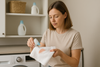 An image of a woman getting makeup stains out of white towels