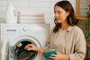 An image of a woman using laundry pods