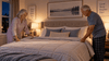 An old couple fixing the bed before sleeping.