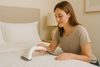 An image of a lady steaming bed sheets to get rid of wrinkles