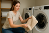 An image of a woman cleaning bath mats