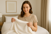 An image of a woman touching bamboo sheets and wondering if they are good