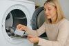 An image of a woman using dryer sheets 