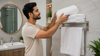 The man is replacing the bath towels.