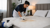 Maid cleaning the mattress.