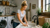 A blonde woman washing a linen cloth using her hands.