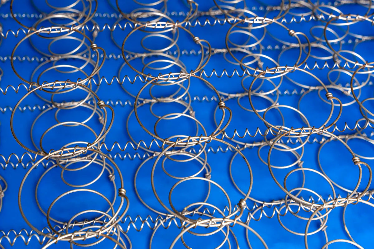 Worn mattress springs showing sagging support structure