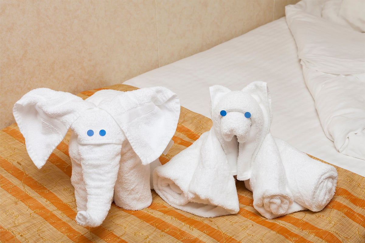 Towel animals sitting on the bathroom counter.