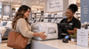 A woman paying for the comforter she purchased at the counter.