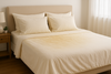 A yellowish bed sheet cover