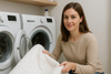 An image of a woman loading a cooling blanket into a washing machine