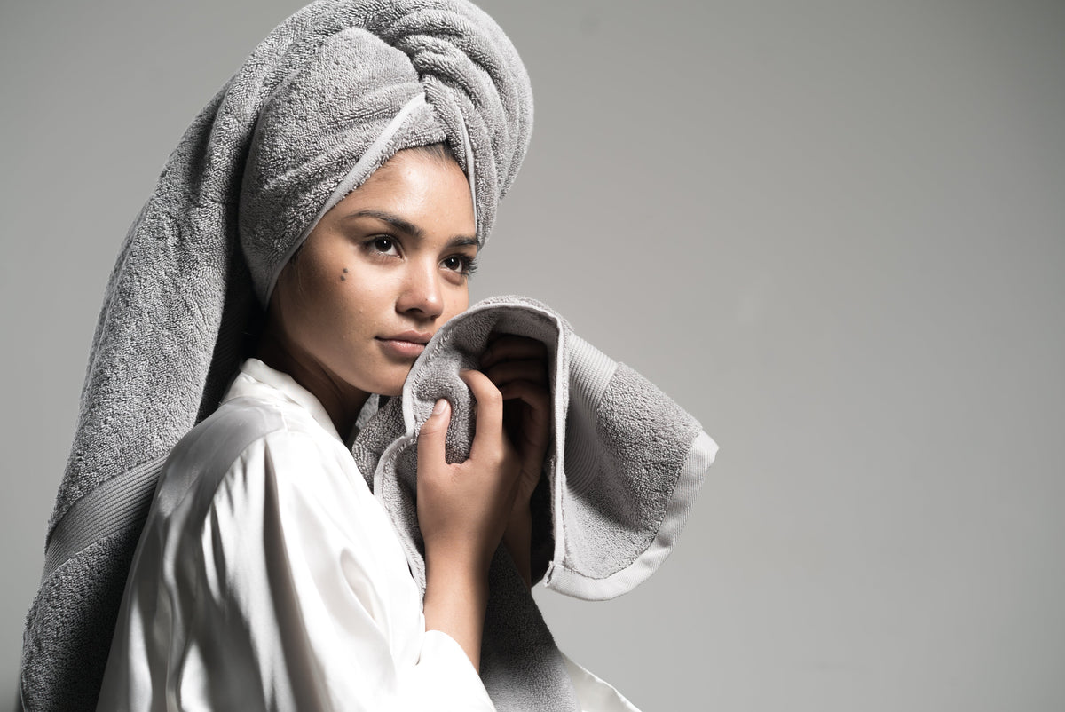 An image of a woman holding up a clean towel