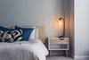 A mattress and blue pillows in a dimly lit room