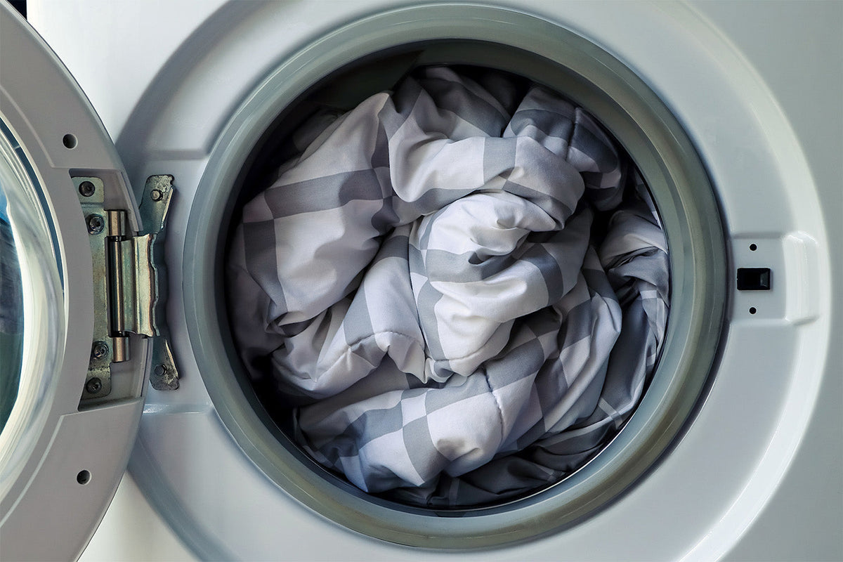 Washing machine drum filled with laundry.