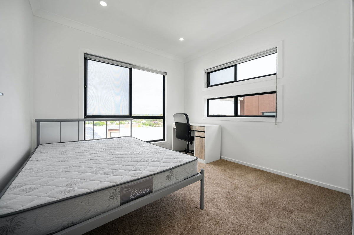 white mattress in an open undecorated room.
