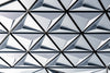 Abstract geometric pattern with repeating triangular shapes in white and gray