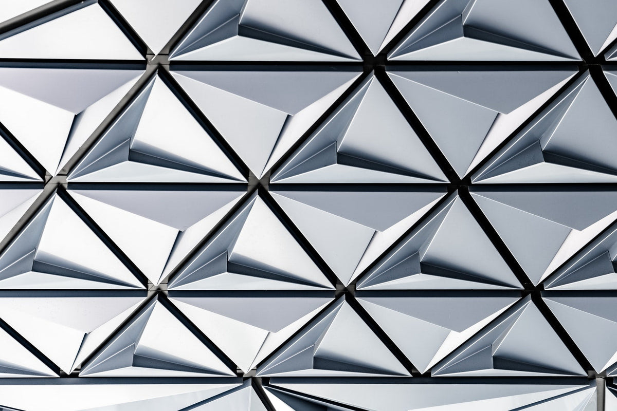 Abstract geometric pattern with repeating triangular shapes in white and gray
