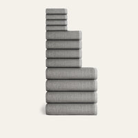 Stack of gray checkered towels on a white background