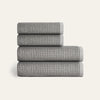 Stack of four gray textured towels on a white background