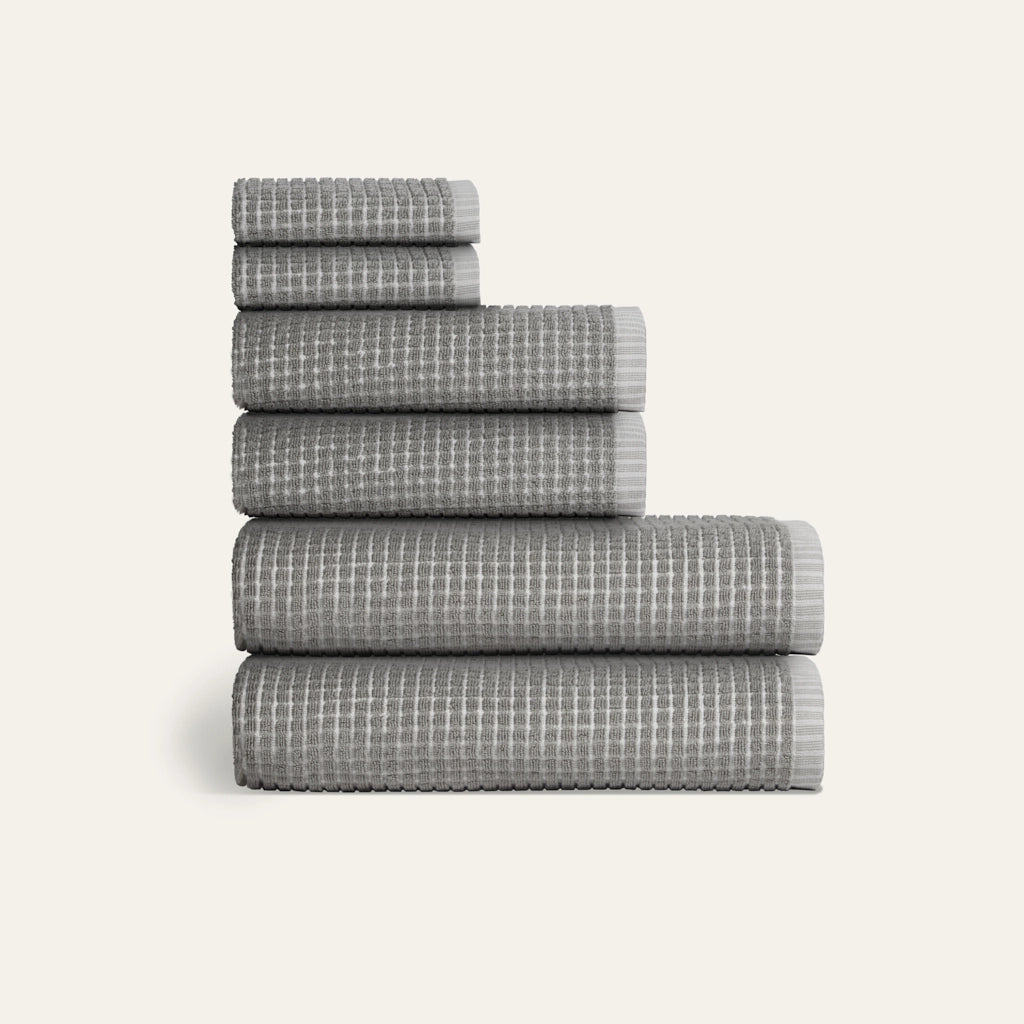 Stack of gray checkered towels on a white background