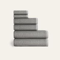 Stack of gray checkered towels on a white background