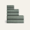 Stack of green checkered towels on a white background
