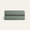 Two folded textured towels on a light beige background