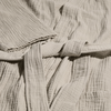 Close-up of textured beige fabric with a belt