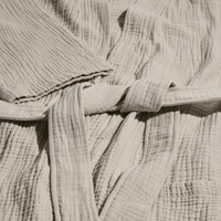 Close-up of textured beige fabric with a belt