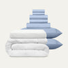 Stack of light blue and white bedding on a white background