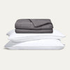 Gray comforter and pillows on a light gray background