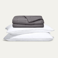Gray comforter and pillows on a light gray background