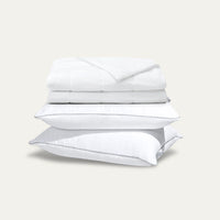 Stack of white bedding on a light gray background