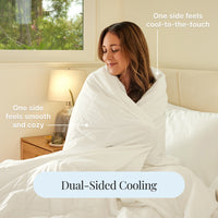 Woman wrapped in a white cooling blanket with text indicating dual-sided properties.