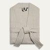 Light gray textured robe with a belt on a white background