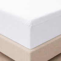 Close-up of a fitted sheet on a bed with a beige border.