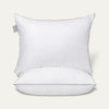 White pillow with a gray tag on a light gray background
