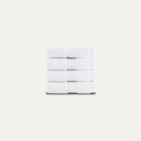 Stack of white towels on a light beige background