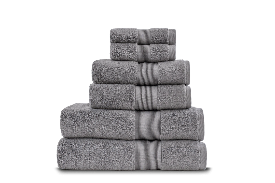 A stack of gray towels including bath towels, hand towels, and washcloths.