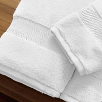 Folded white towel on a wooden surface