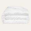 White comforter on a beige background