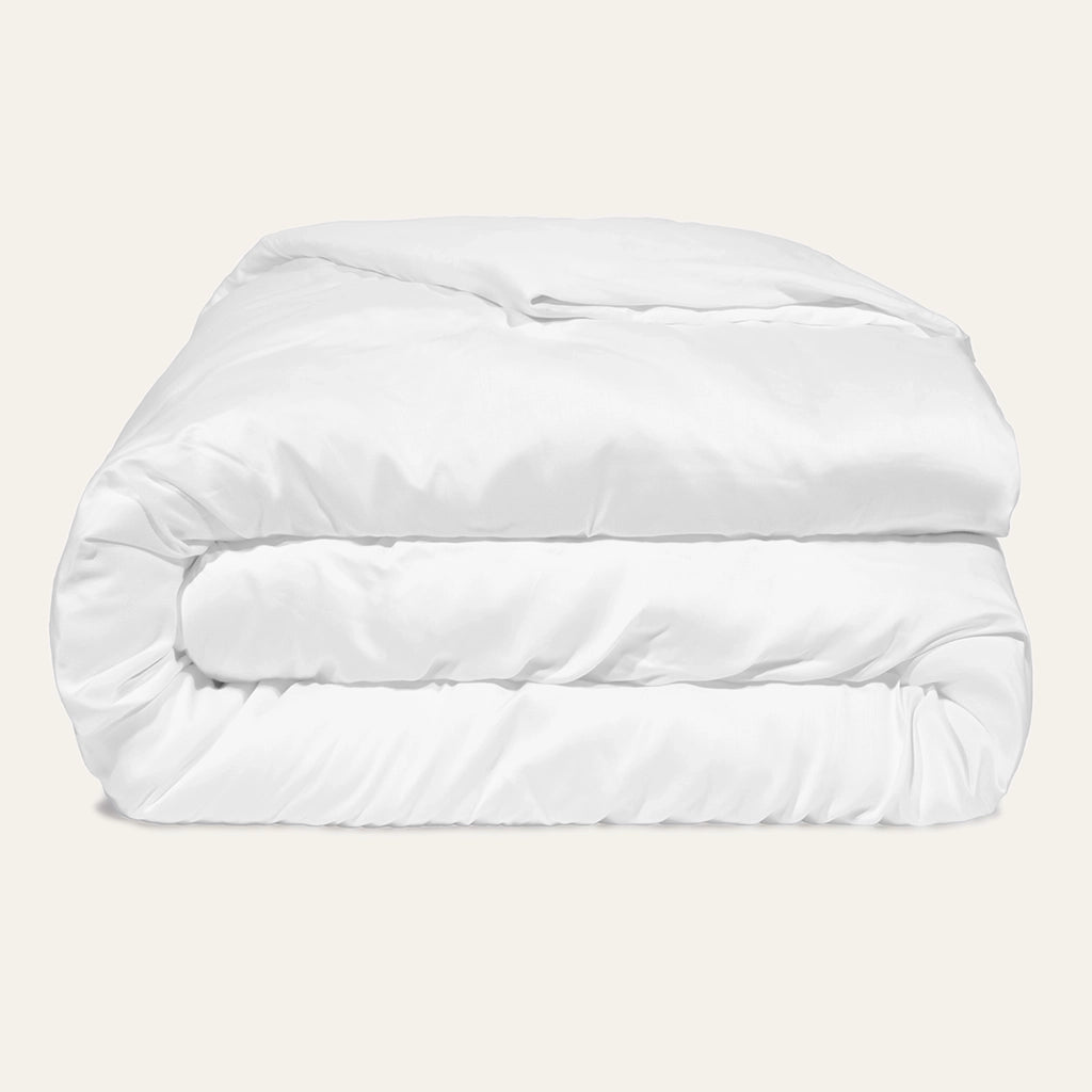 White comforter on a beige background