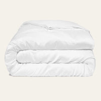White comforter on a beige background