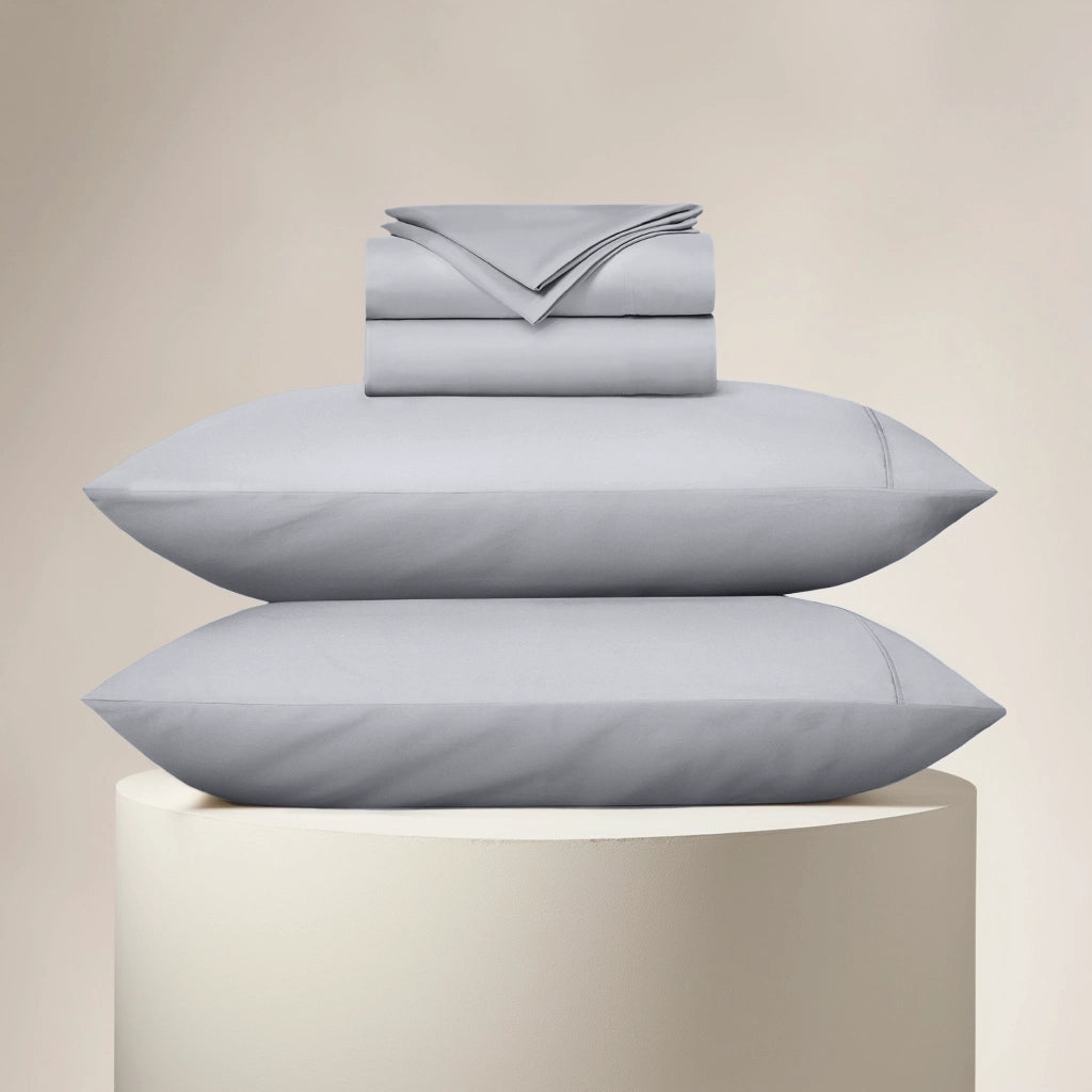 Stack of light blue bedding on a beige background