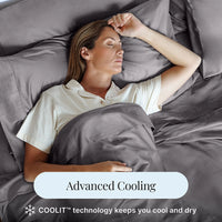 Woman sleeping under gray bedding with 'Advanced Cooling' text overlay