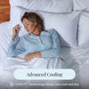 Woman sleeping in a bed with white bedding and pillows, featuring text about COOLIT technology.