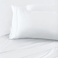 White pillow on a white bed