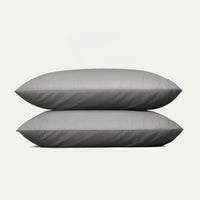 Two gray pillows stacked on a white background