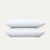 Two white pillows stacked on a light gray background