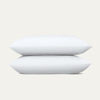 Two white pillows stacked on a light gray background